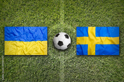 Ukraine vs. Sweden flags on soccer field