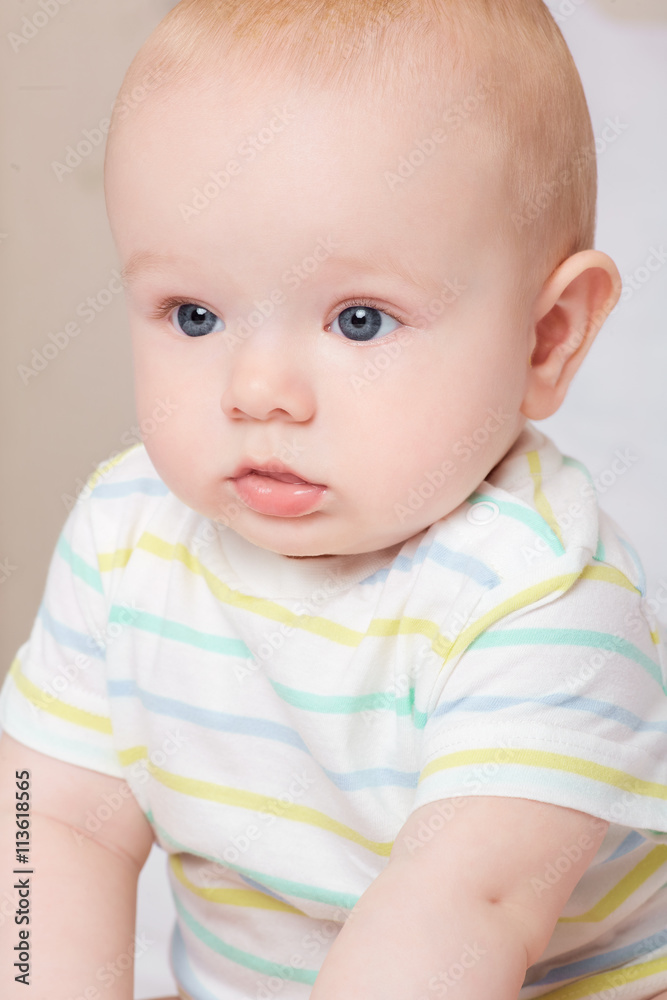 Child,baby happiness concept. Cute baby boy sits quietly on the