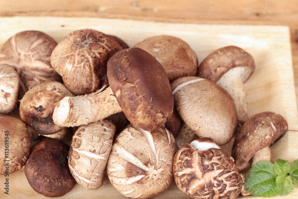 Shiitake mushrooms for cooking on wood background. Shiitake mushrooms for cooking on wood background.