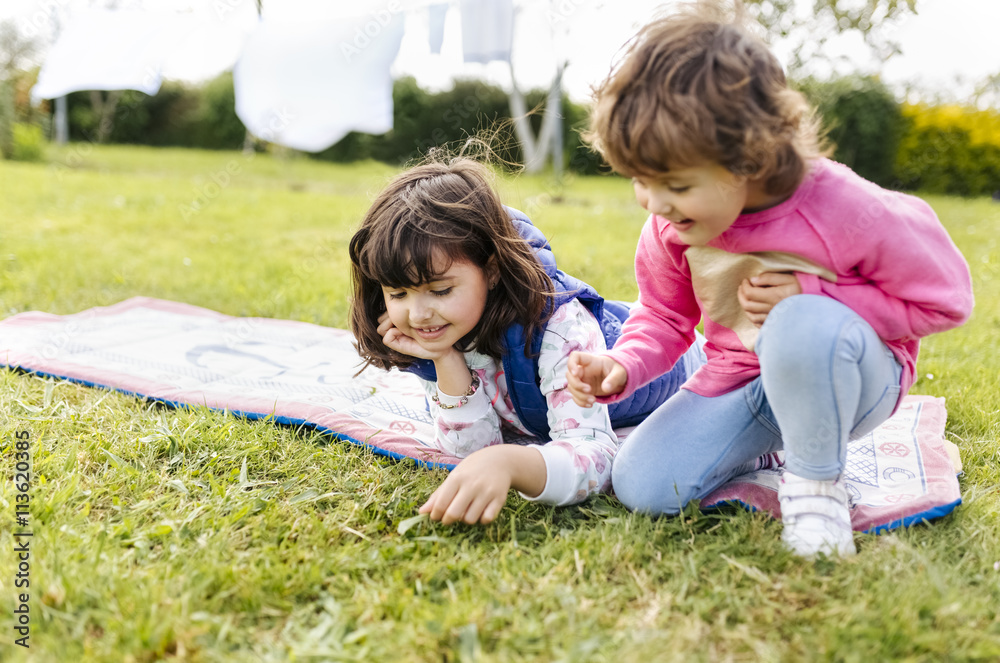 Two girls playing on a meadow