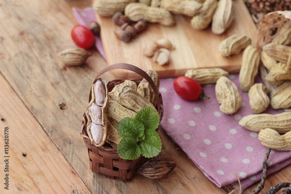 Peanut and boiled peanuts on wood background.