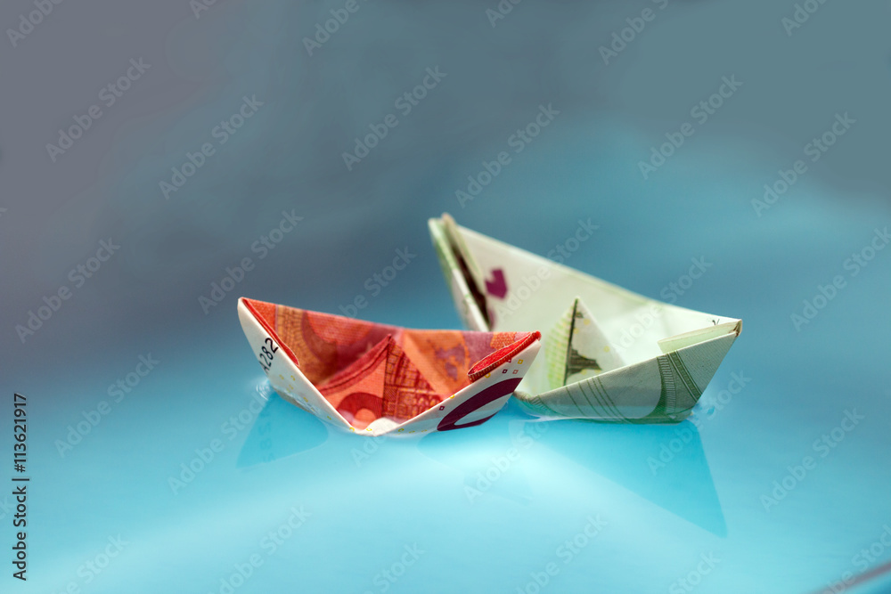 paper boats out of money in water