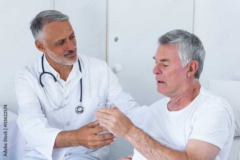Male doctor and senior man interacting with each other Male doctor and senior man interacting with each other
