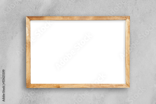 Blank picture frame on a white concrete wall