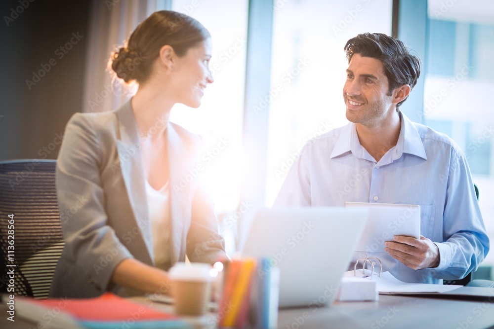 Businesswoman having a discussion with coworker Businesswoman having a discussion with coworker