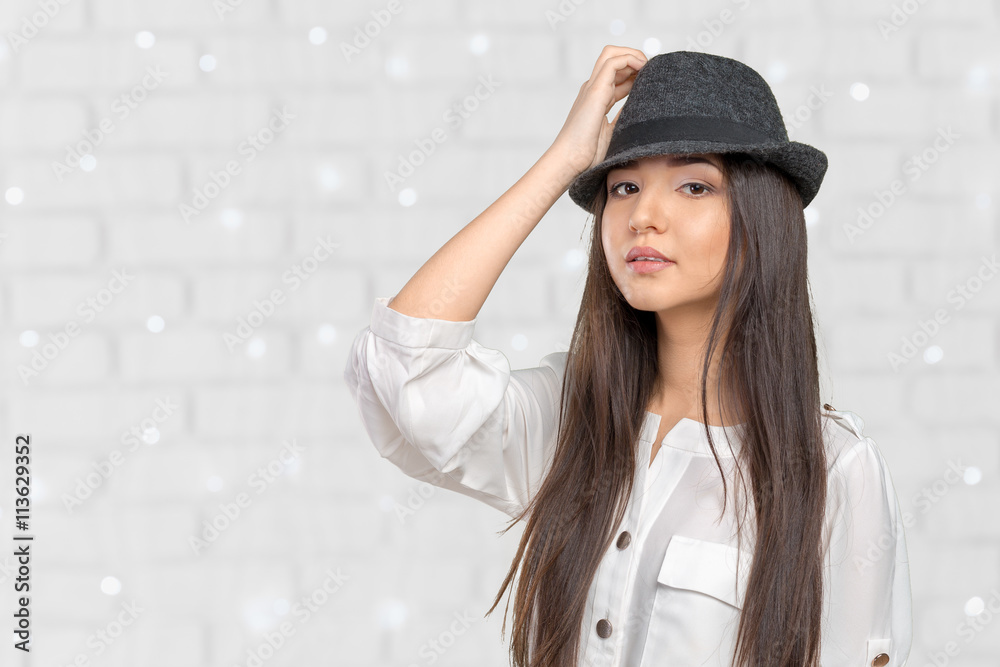 Beautiful young woman wearing summer fedora straw hat posing