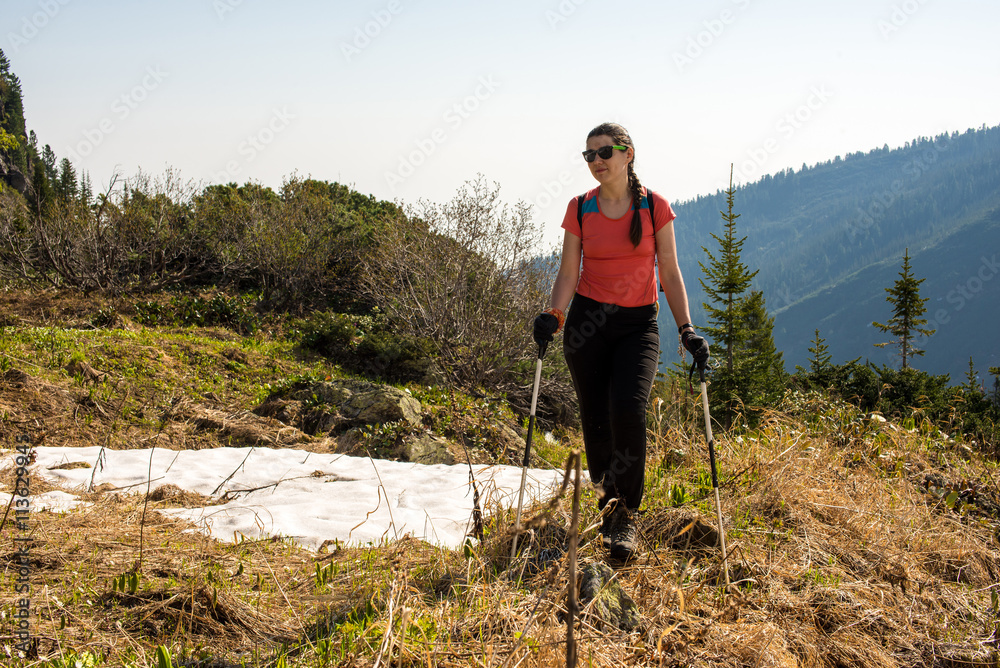 Hiker young woman walking in the mountains