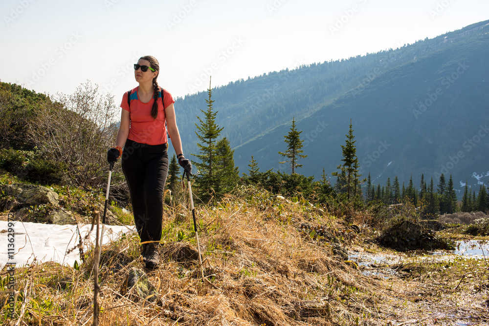 Hiker young woman walking in the mountains