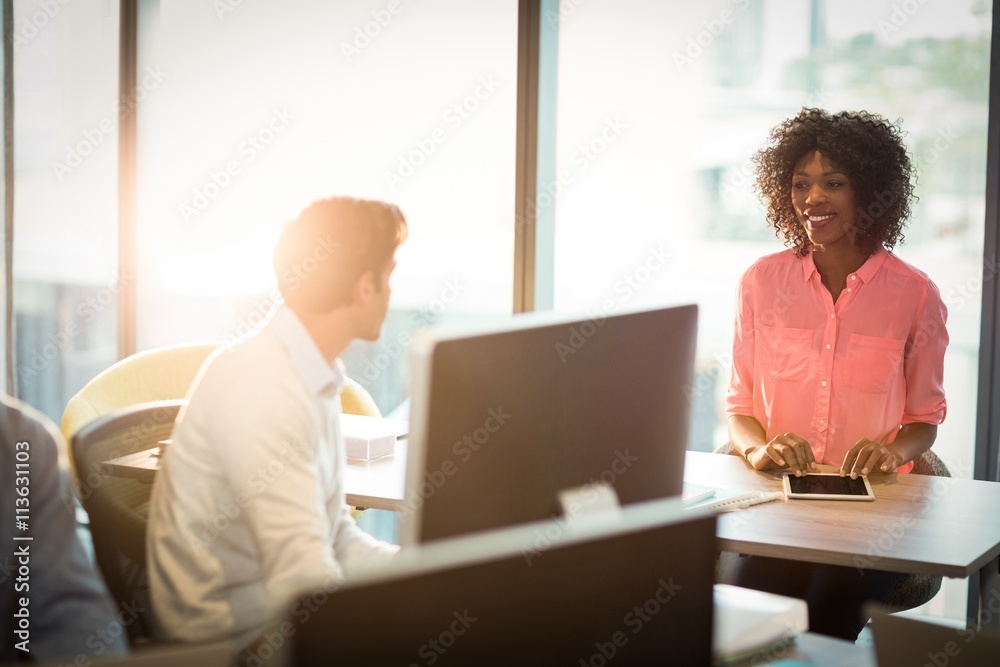 Businesswoman having a discussion with coworker Businesswoman having a discussion with coworker