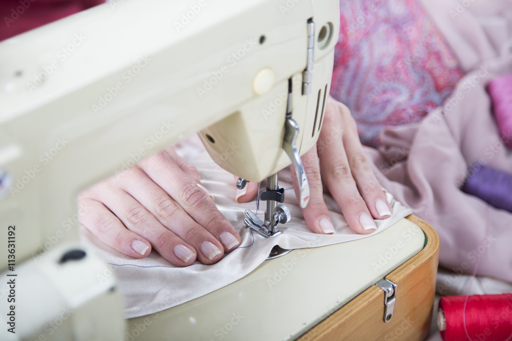 Sewing Process - Women's hands behind her sewing,selective focus

