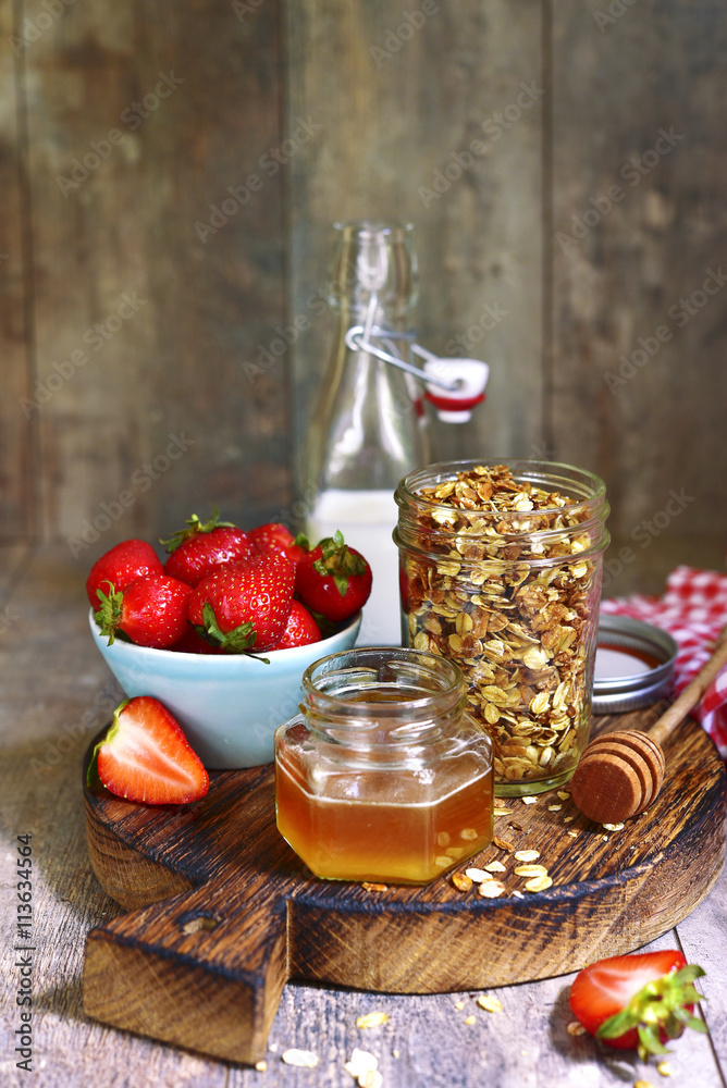 Healthy breakfast: granola with honey and strawberry.