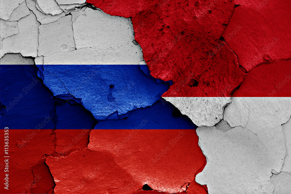flags of Russia  and Indonesia painted on cracked wall