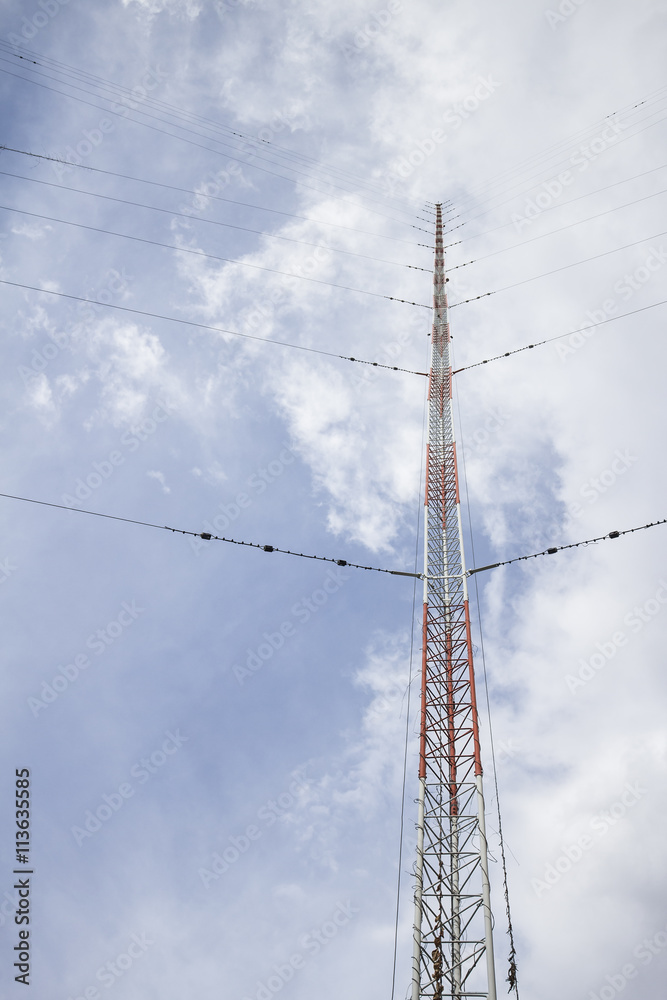 The communication antenna tower on blue sky The communication antenna tower on blue sky