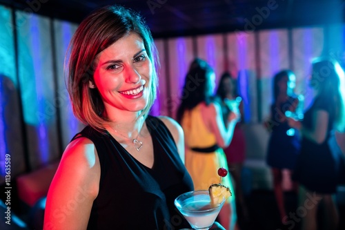 Portrait of young woman having a cocktail