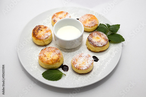 Cheese biscuits with cream and mint on the plate on white background