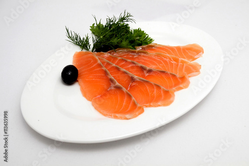 Slice of salmon on the plate on white background