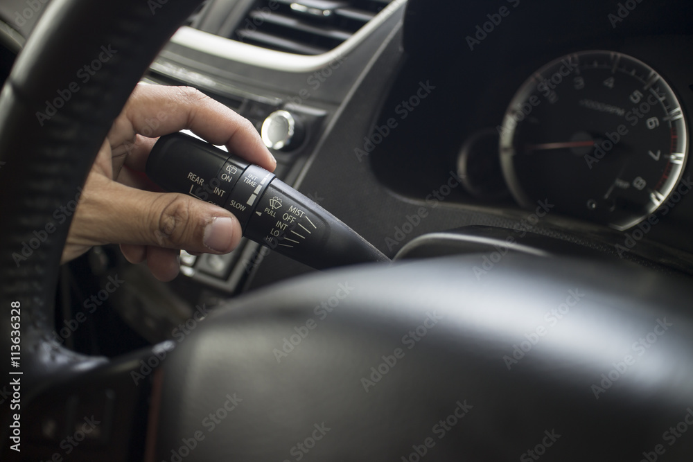 The Finger Push a wiper control button on the car steering wheel