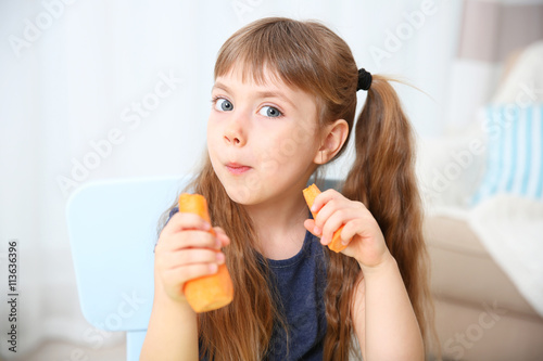 Little girl with carrot in ...
