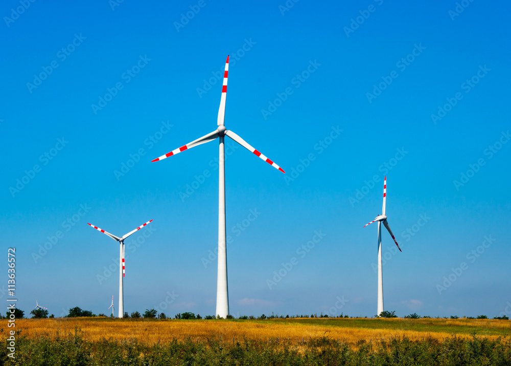 Wind turbine electric power generators in the filed in Austria on blue sky Wind turbine electric power generators in the filed in Austria on blue sky