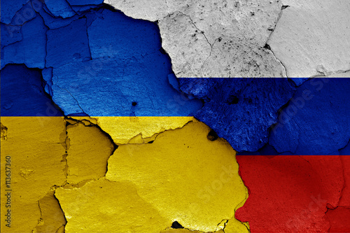 flags of Ukraine and Russia painted on cracked wall