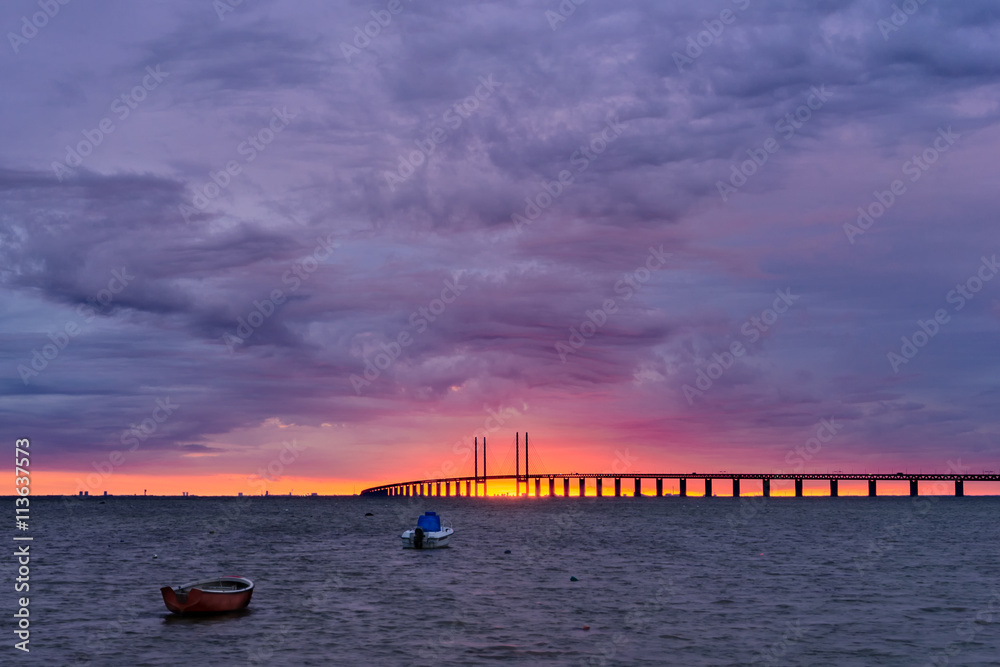 Sun setting between the pillars of the Öresundsbron bridge