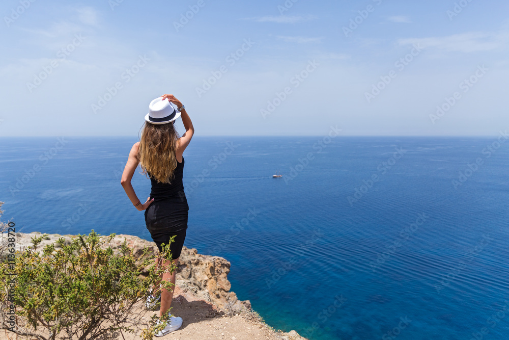 Young girl looks at the sea