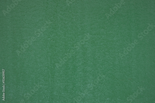 Green painted metal surface closeup as background