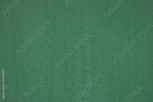 Green painted metal surface closeup as background
