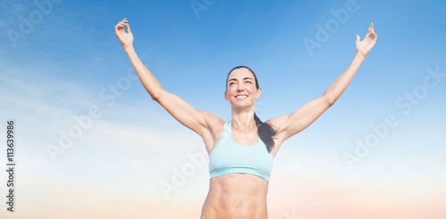 Composite image of portrait of happy sportswoman is raising arms  © vectorfusionart