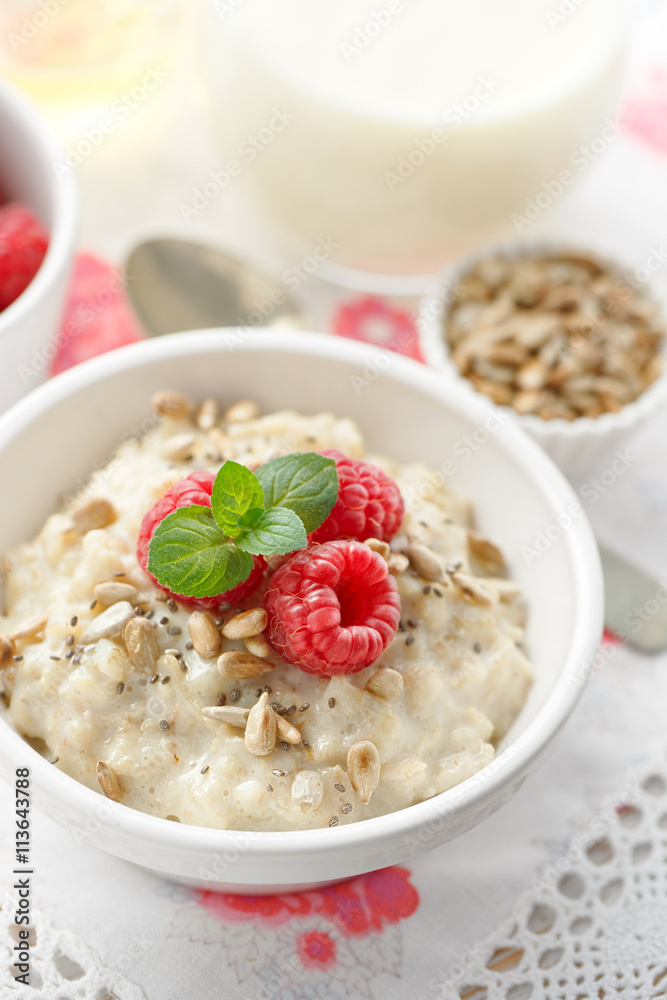 Porridge with fresh raspberries, roasted sunflower and chia seeds, healthy and delicious breakfast Porridge with fresh raspberries, roasted sunflower and chia seeds, healthy and delicious breakfast