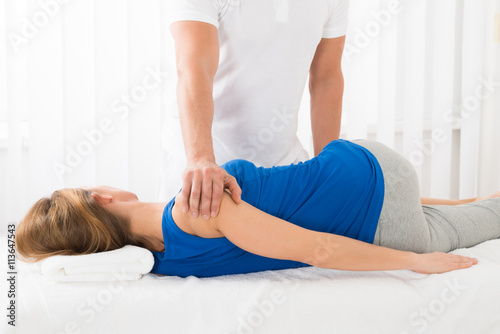 Masseur Doing Massage On Woman