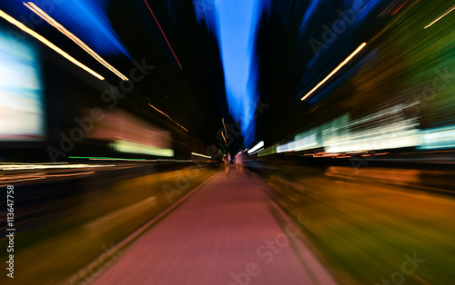 Night city accelerating blurred motion walking people. Speed concept