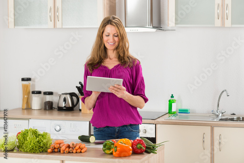 Woman Looking For Recipe On Digital Tablet