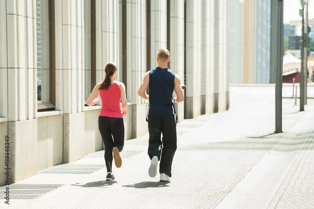 Fototapeta premium Young Couple Running Together