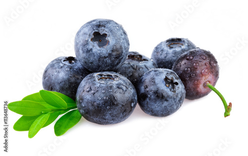 Blueberries on white, organic berries with leaves.