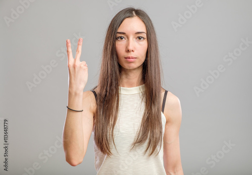 Young casual woman making gesture