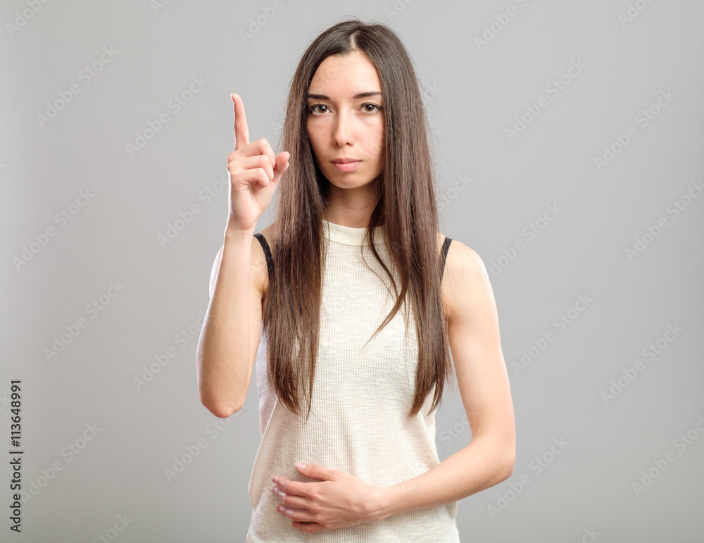 Girl showing the index finger up Girl showing the index finger up