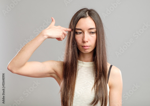 Woman showing suicide sign