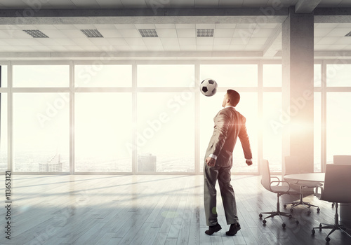 Playing football in office . 3D render