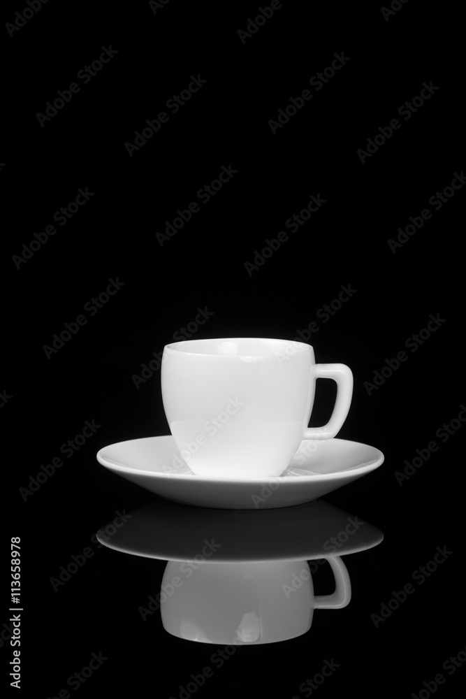White cup on glossy black background White cup on glossy black background