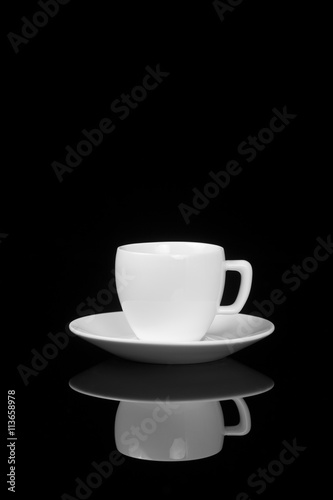 White cup on glossy black background