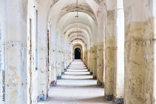 Castle tunnel with a series of arches in the ruined Bastion fortress in the Slovak city of Komarno. © dmpalino