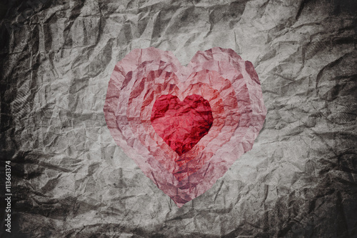 Crumpled paper texture with cut as heart shape in many layers, abstract concepts about love or heart disease, collage style