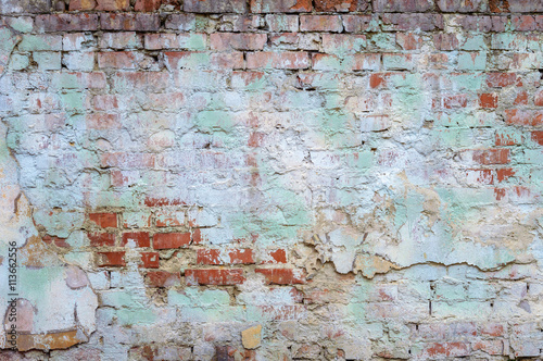 background old brick wall with remnants of plaster