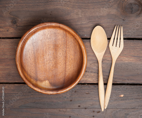 Wooden dish and spoon set on wooden background,Top view