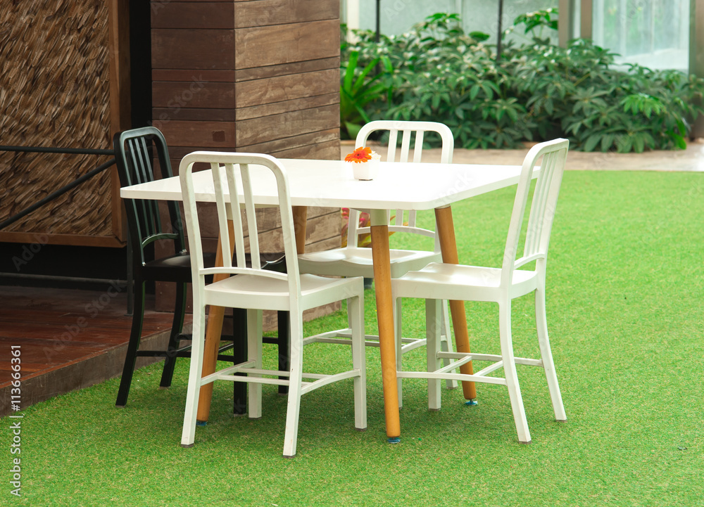 Green garden and white table set
