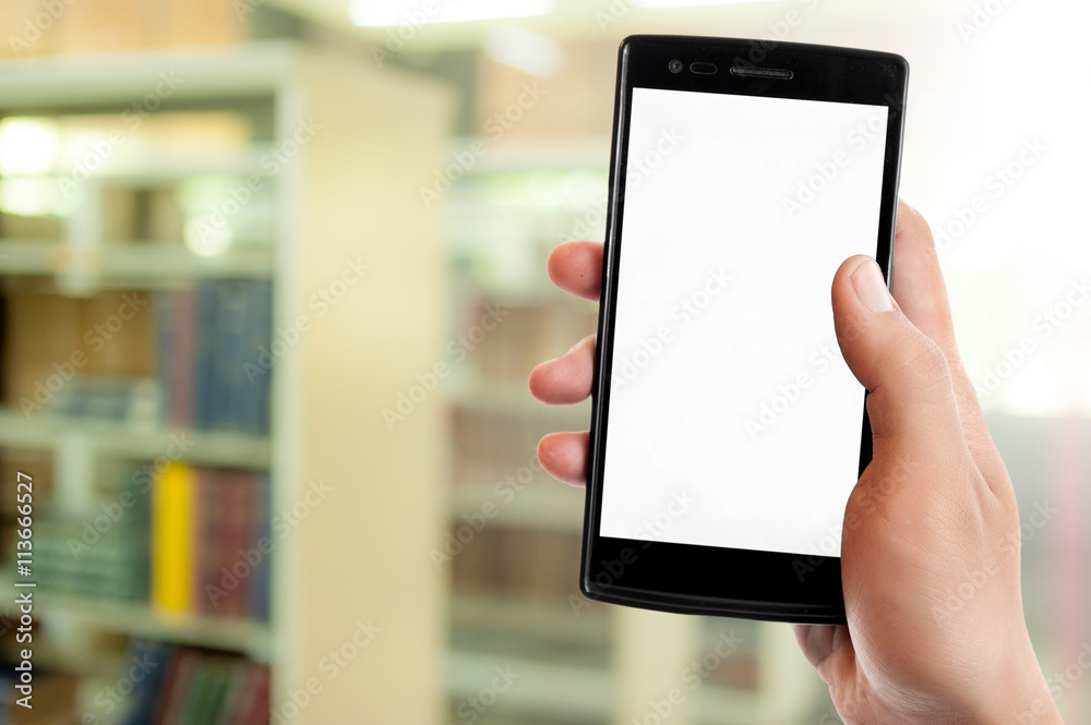 Hand holding smart phone on blur library room background
