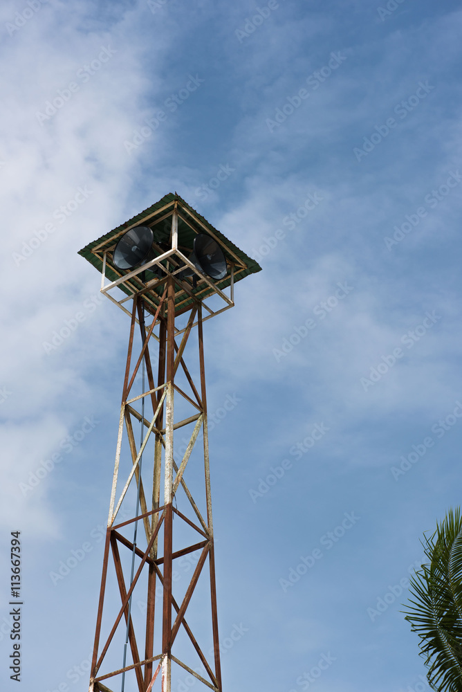 Loudspeakers broadcast tower with a blue sky background Loudspeakers broadcast tower with a blue sky background