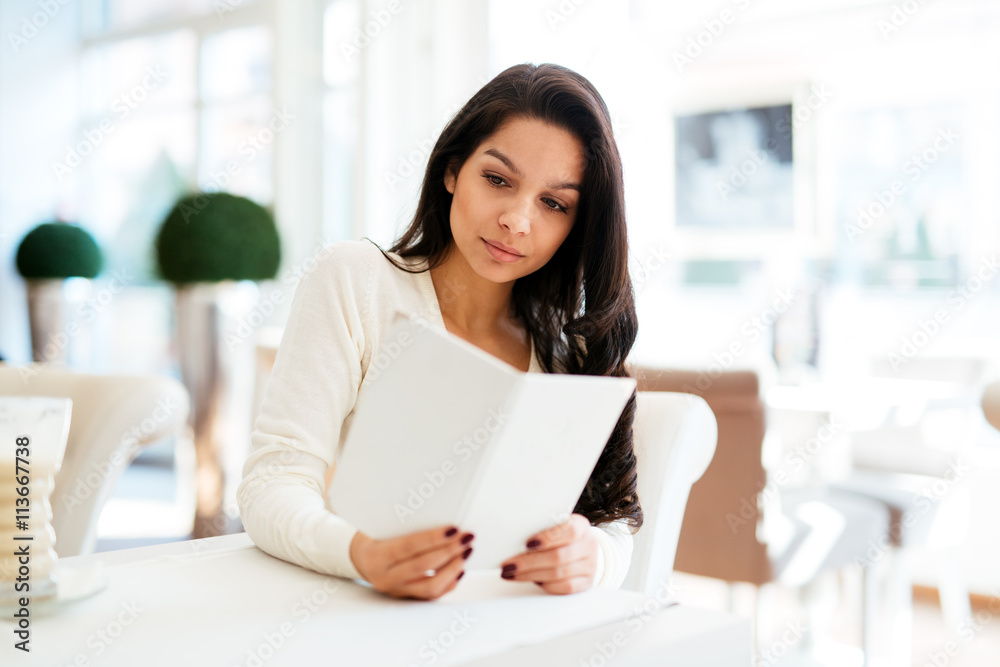 Beautiful woman looking at menu Beautiful woman looking at menu