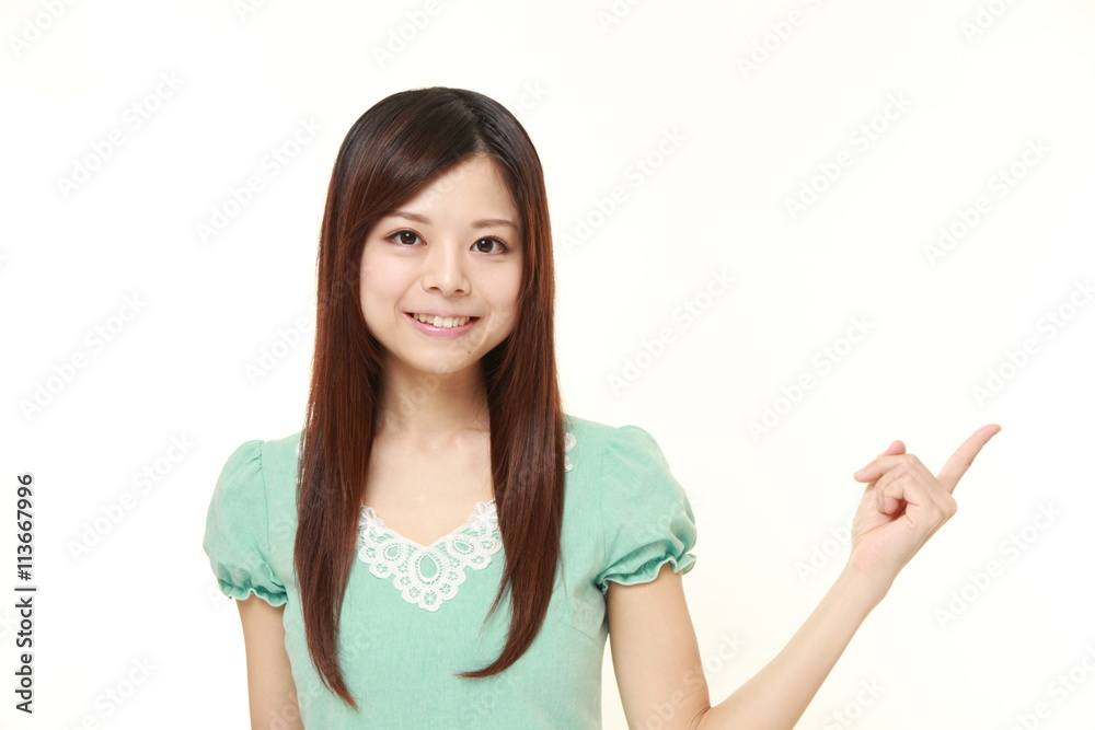 young Japanese woman wearing a green dress presenting young Japanese woman wearing a green dress presenting